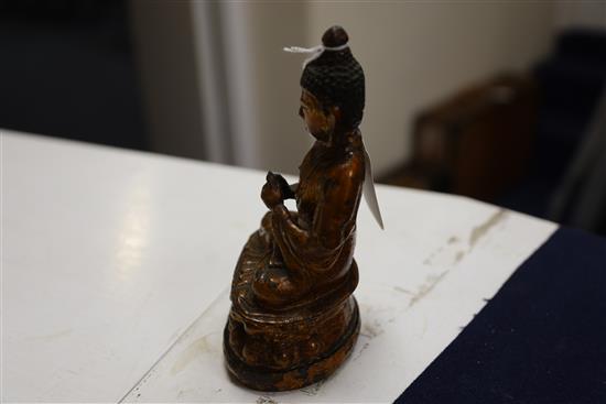 A Chinese gilt lacquered bronze figure of Buddha, 18th/19th century, H. 7.3cm, repair to neck